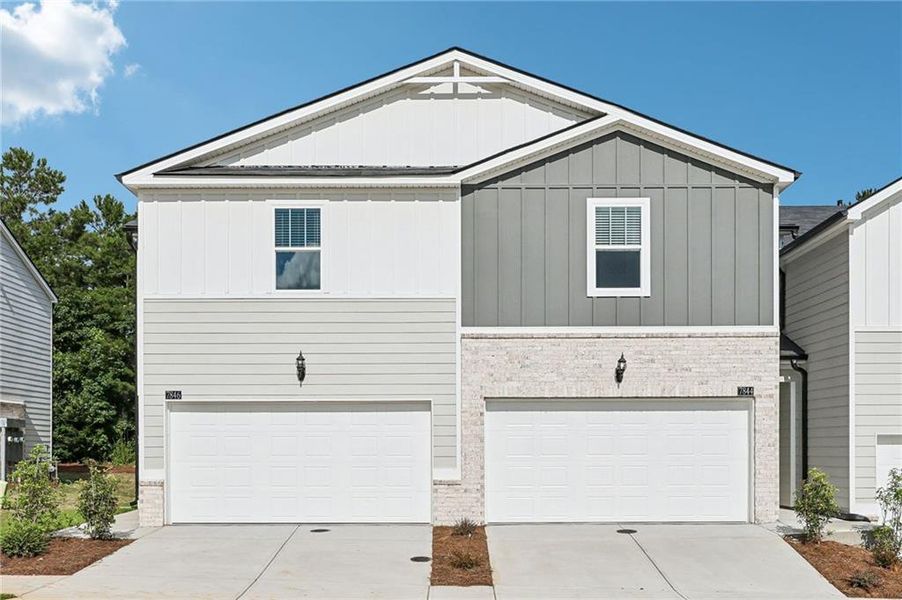 Front exterior of a new home in Artisan Walk, Fairburn, GA, highlighting curb appeal (Image 2). Front exterior of a new home in Artisan Walk, Fairburn, GA, highlighting curb appeal (Image 2).