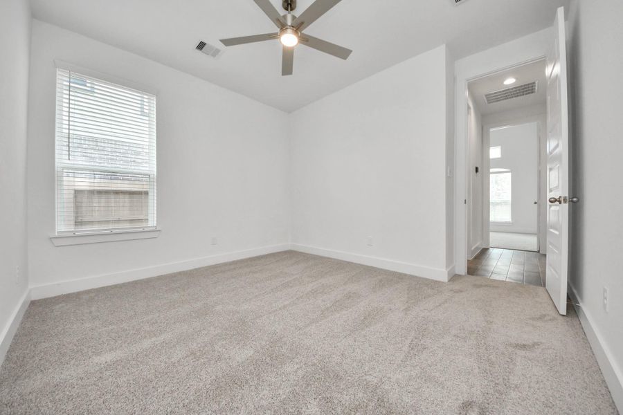 Generously sized secondary bedrooms featuring spacious closets, soft and inviting carpeting underfoot, large windows allowing plenty of natural light, and the added touch of privacy blinds for your personal retreat.