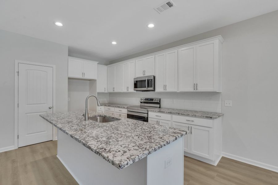 Representative furnished interior of a home built from the The Hatteras by Smith Family Homes in Ramsey Landing, Rincon (Image 6).