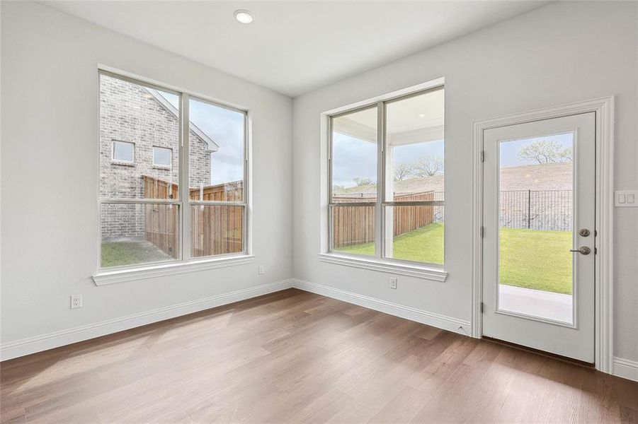 Spare room featuring wood-type flooring