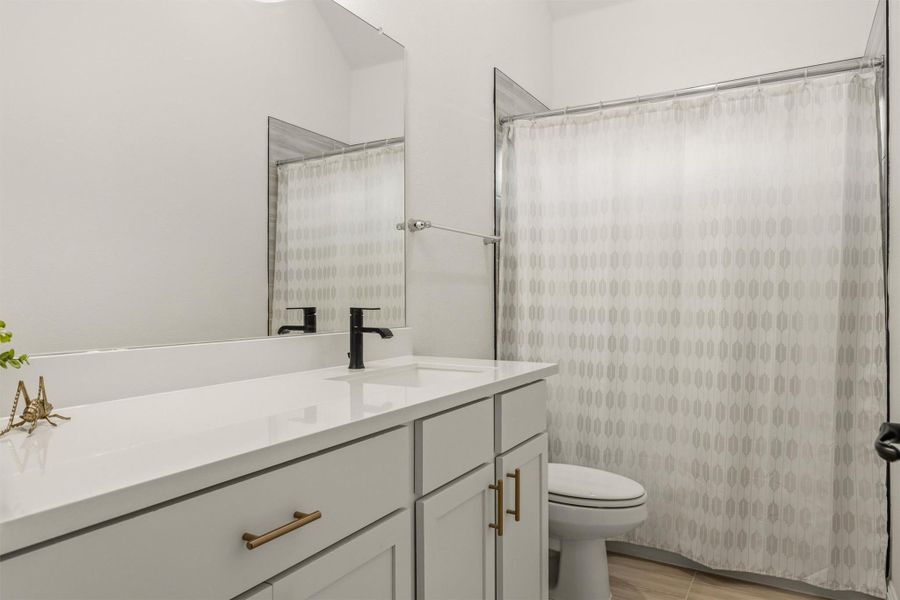Full bathroom with vanity and a shower with curtain