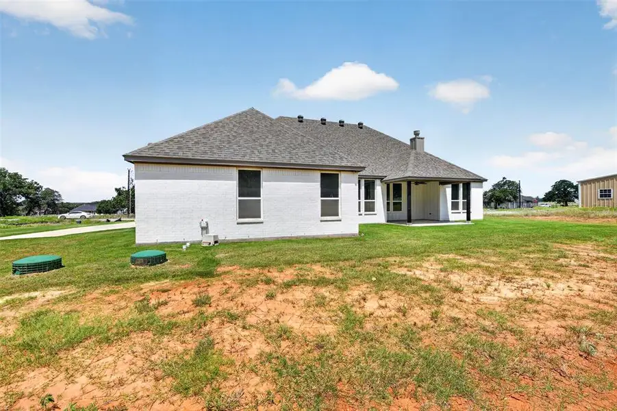 White brick exterior with gray shingle roofing White brick exterior with gray shingle roofing