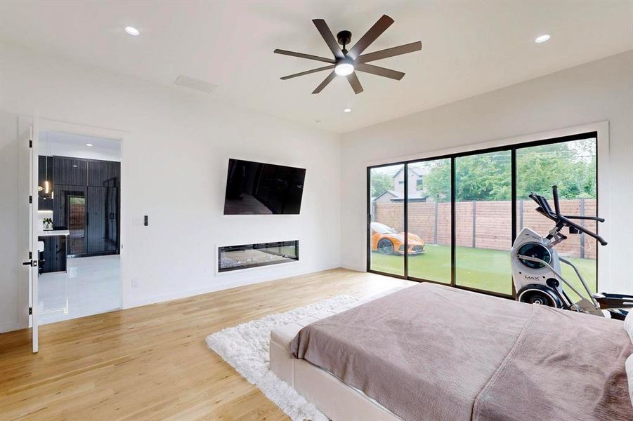 Bedroom featuring access to outside, wood finished floors, recessed lighting, and ceiling fan Bedroom featuring access to outside, wood finished floors, recessed lighting, and ceiling fan