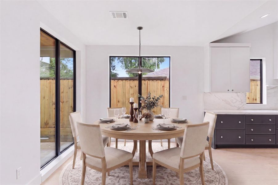 Perfectly positioned between the kitchen and living area, this open dining space creates an inviting setting for everyday meals and entertaining alike. Virtually stagged.