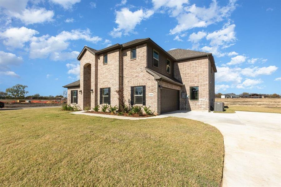Front exterior of a new home in Stone Henge II, Sanger, TX, highlighting curb appeal (Image 2).