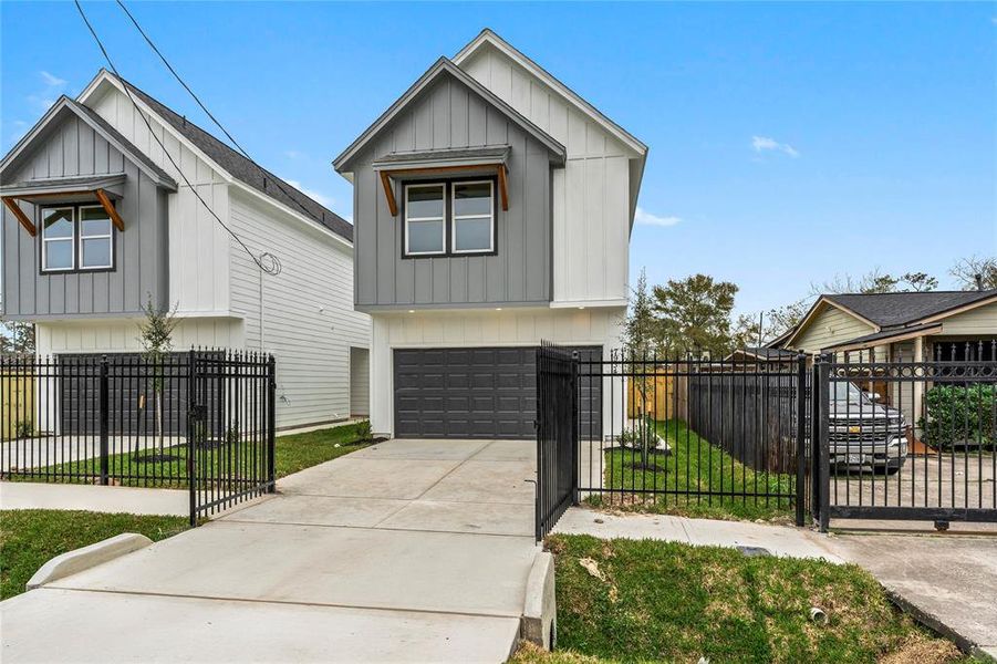 From the street, you’ll see not one but two beautifully designed homes, framed by a privacy gate that adds both security and elegance to your first impression. (Photo may be enhanced)