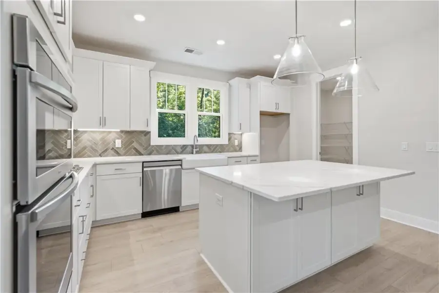 Gleaming stone countertops and a spacious central