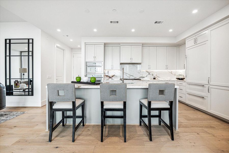 The oversized center island features a built-in sink, and breakfast bar seating. The oversized center island features a built-in sink, and breakfast bar seating.