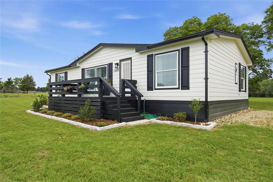 Exterior with light-toned siding and dark trim accents