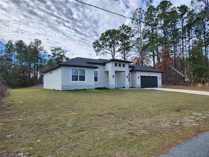 Front exterior of a new home in , Ocala, FL, highlighting curb appeal (Image 25).