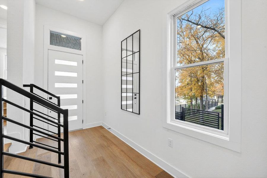Entrance foyer featuring light wood-type flooring and healthy amount of natural light