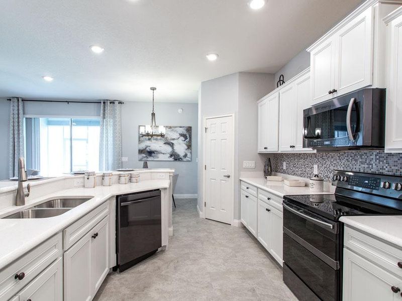 Kitchen with walk-in pantry and breakfast bar - Westin ll home plan by Highland Homes