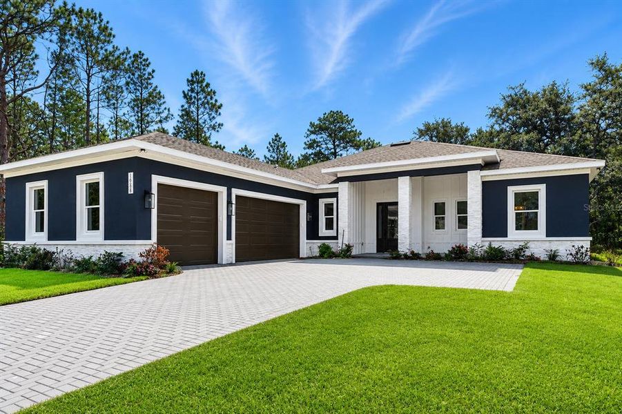 Front exterior of a new home in , Weeki Wachee, FL, highlighting curb appeal (Image 34).