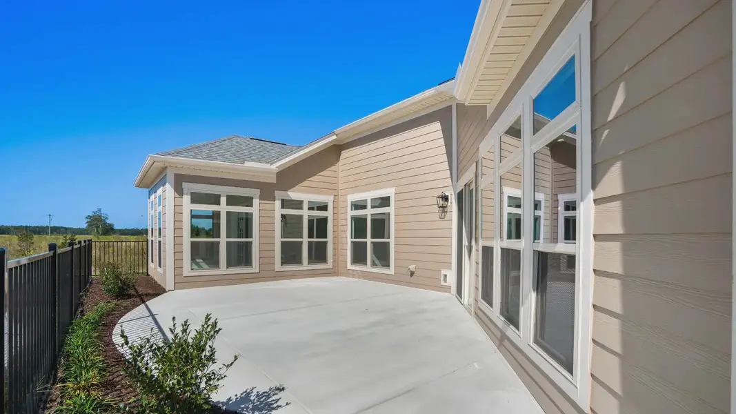 Exterior details and patio area of a home in Courtyards by Carrell, Ocean Isle Beach (Image 3). Exterior details and patio area of a home in Courtyards by Carrell, Ocean Isle Beach (Image 3).