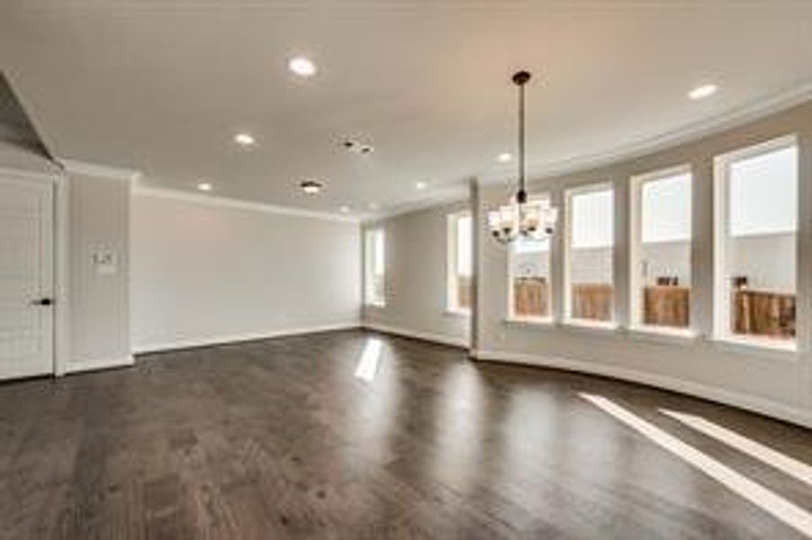 Unfurnished room with dark hardwood / wood-style flooring and ornamental molding