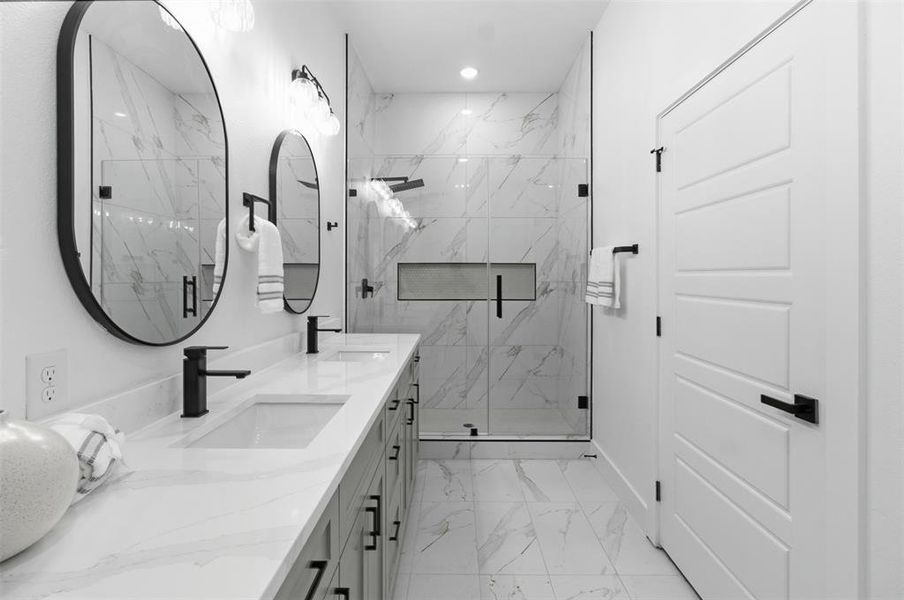 Double vanity with integrated sinks, quartz countertop, and matte black fixtures