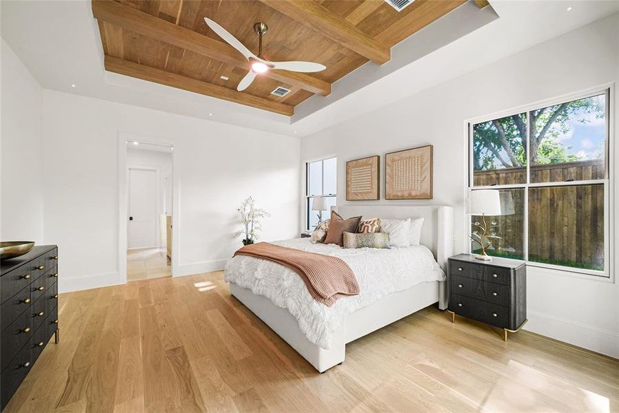 Recessed tray ceiling with wood-finish beams and ceiling fan