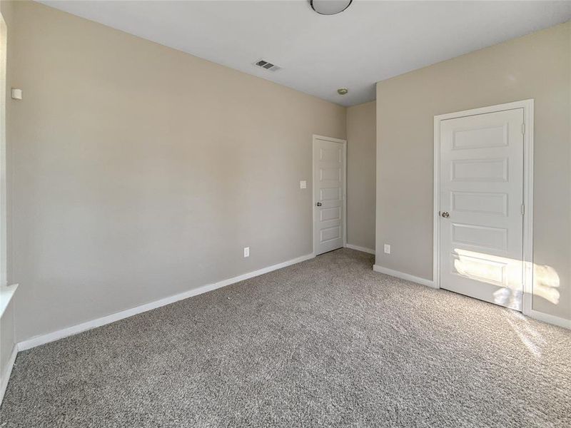 Unfurnished bedroom featuring baseboards and carpet