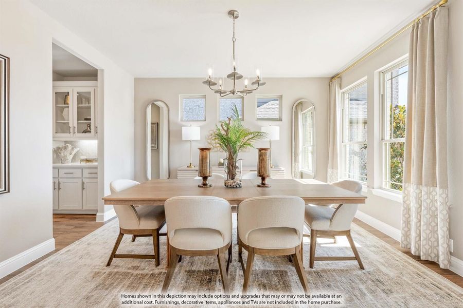 Formal dining room with wood table, upholstered chairs, chandelier, and large windows with natural light Formal dining room with wood table, upholstered chairs, chandelier, and large windows with natural light