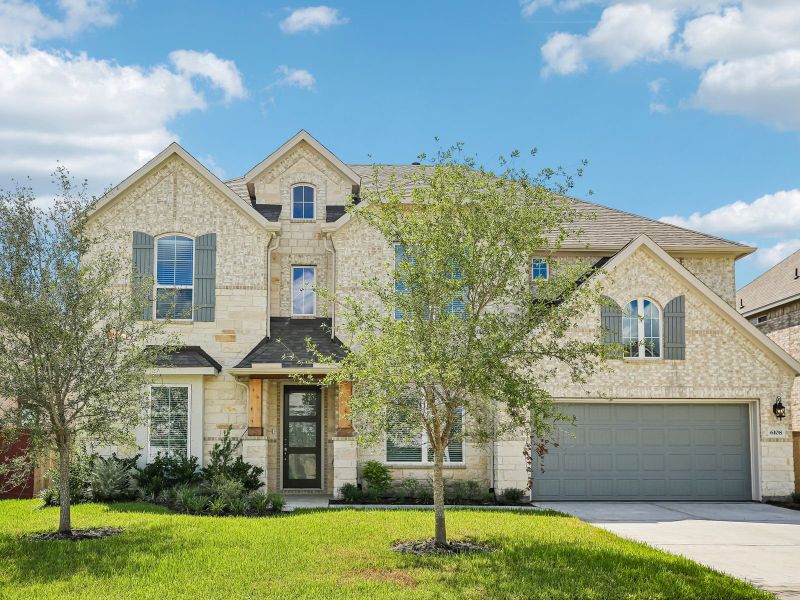 Front exterior of a new home in Massey Oaks - Estate Series, Pearland, TX, highlighting curb appeal (Image 1). Front exterior of a new home in Massey Oaks - Estate Series, Pearland, TX, highlighting curb appeal (Image 1).