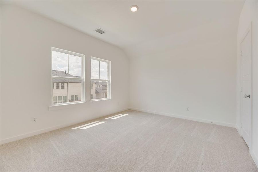 Unfurnished room with light colored carpet, recessed lighting, and vaulted ceiling Unfurnished room with light colored carpet, recessed lighting, and vaulted ceiling