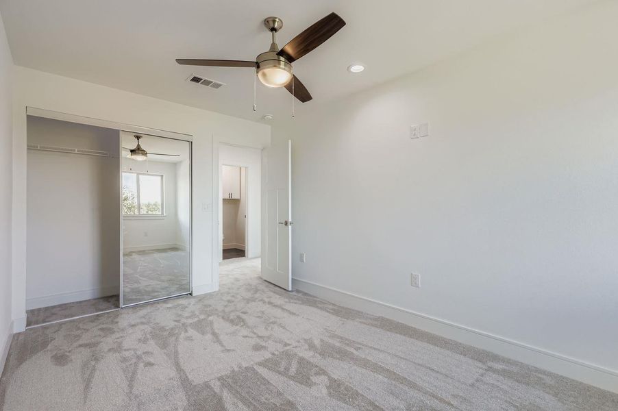 Unfurnished bedroom featuring ceiling fan, carpet, a closet, and recessed lighting