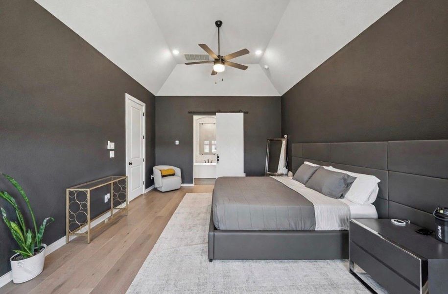 The custom paint gives this room a moody, high-end vibe complete with barn door leading to the ensuite.