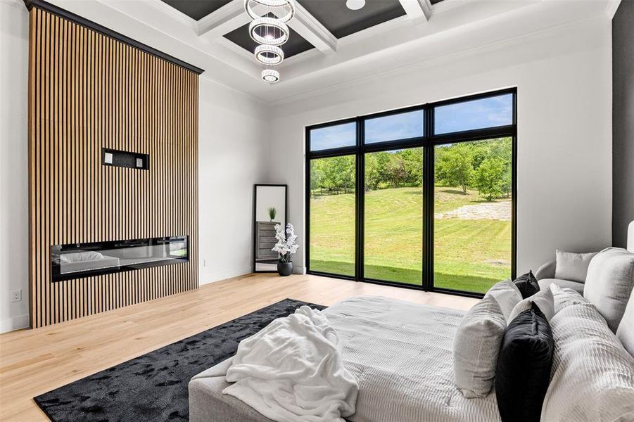Expansive room featuring a wood-slat accent wall with an integrated fireplace and a large window overlooking green landscape