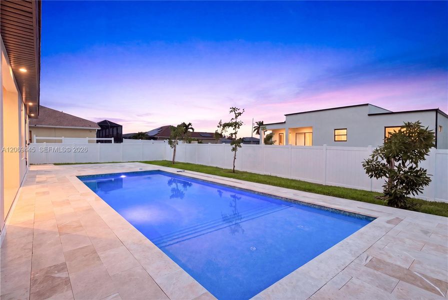 Sparkling pool with elegant marble deck creates the perfect setting for relaxing and entertaining. Sparkling pool with elegant marble deck creates the perfect setting for relaxing and entertaining.