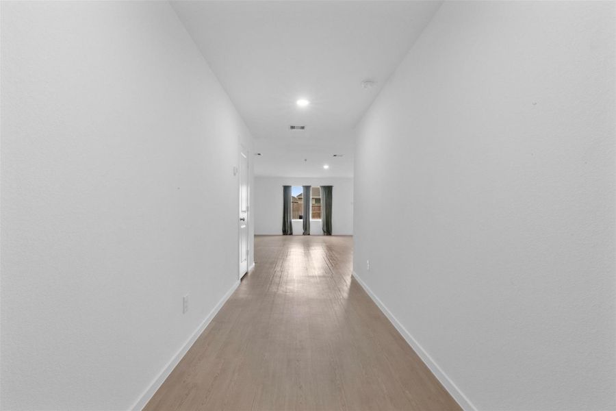 Bright and welcoming entry hallway featuring modern flooring