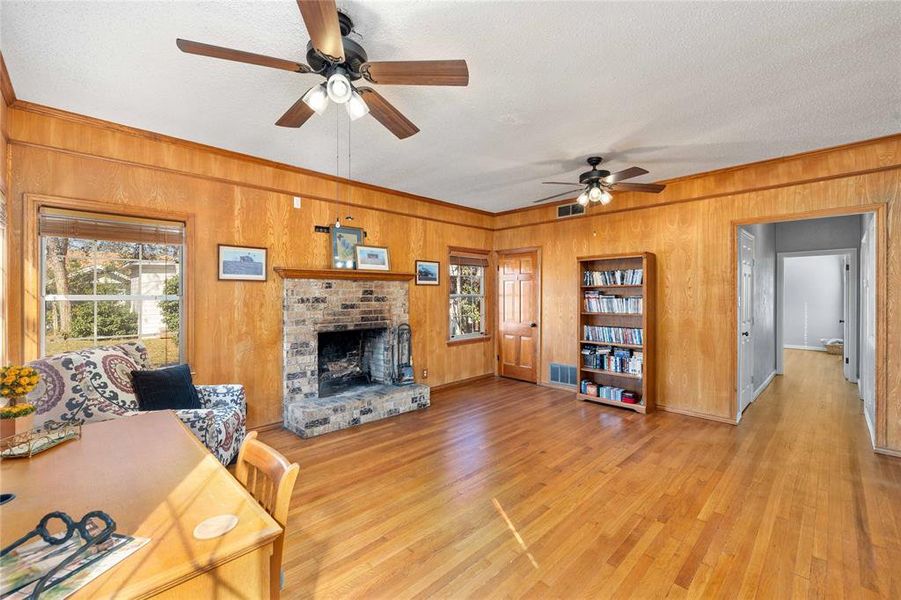 Den with wood burning fireplace