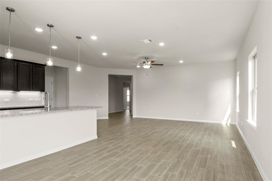 Unfurnished living room featuring ceiling fan, recessed lighting, and light wood-type flooring