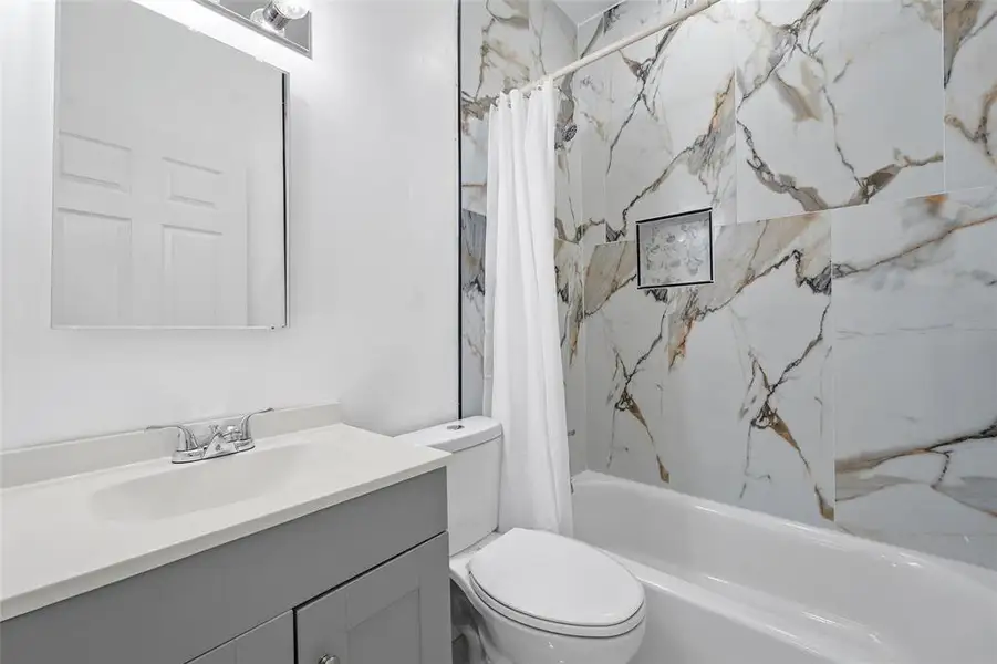 Bathroom featuring vanity and shower / tub combo Bathroom featuring vanity and shower / tub combo