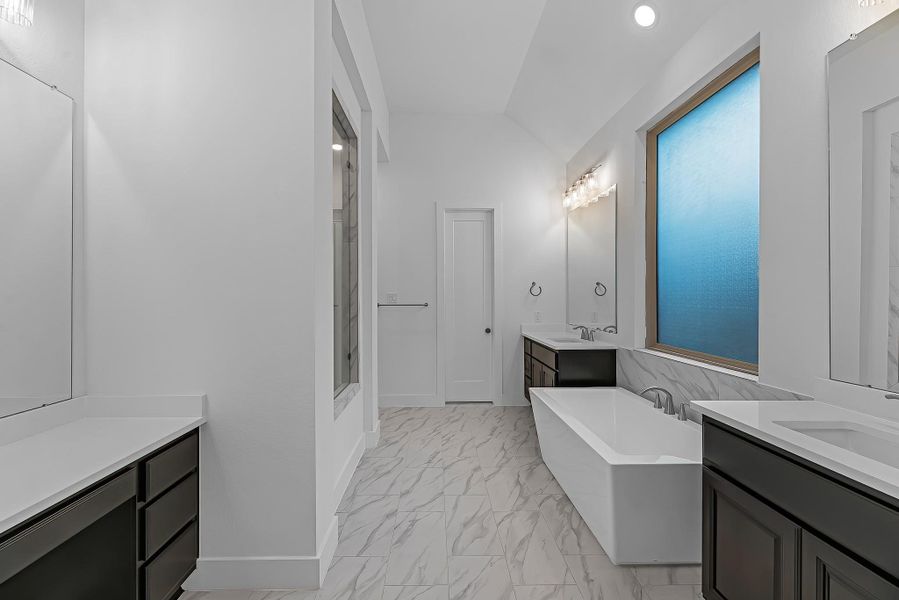 The primary bathroom also includes a useful vanity area separate from the double sinks. The primary bathroom also includes a useful vanity area separate from the double sinks.