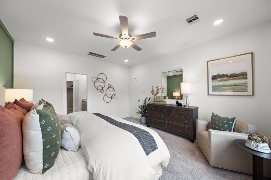 A bedroom with a bed and a fan. A bedroom with a bed and a fan.