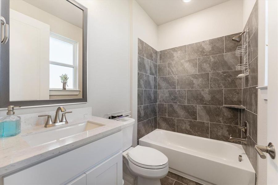 Third full bathroom with upgraded cabinetry and tile