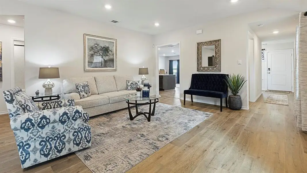 Living area featuring light wood-type flooring and recessed lighting Living area featuring light wood-type flooring and recessed lighting