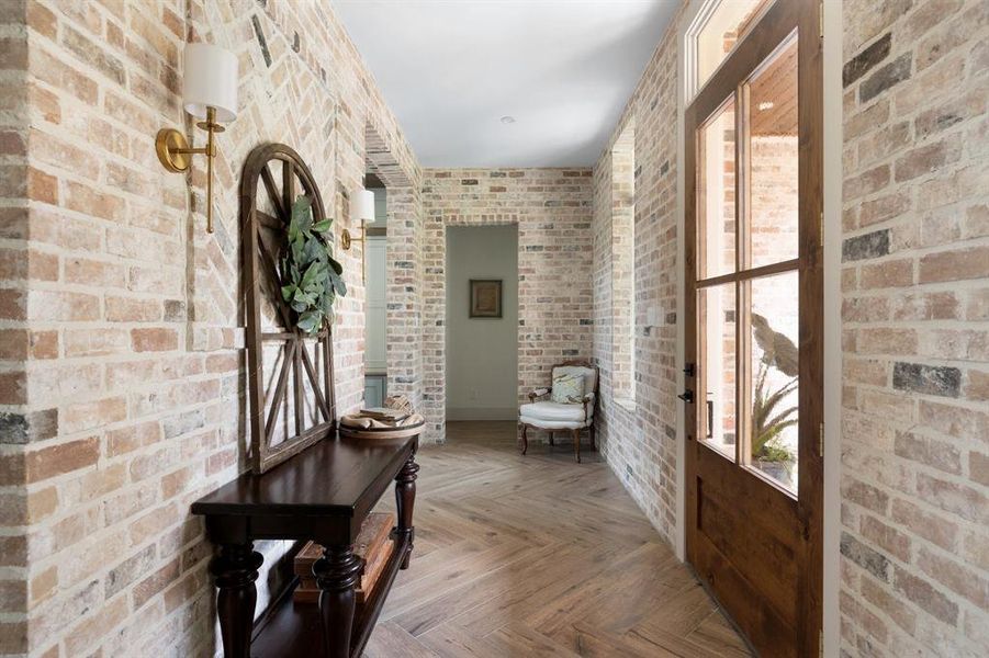 Dedicated foyer with custom brick & wood accents.