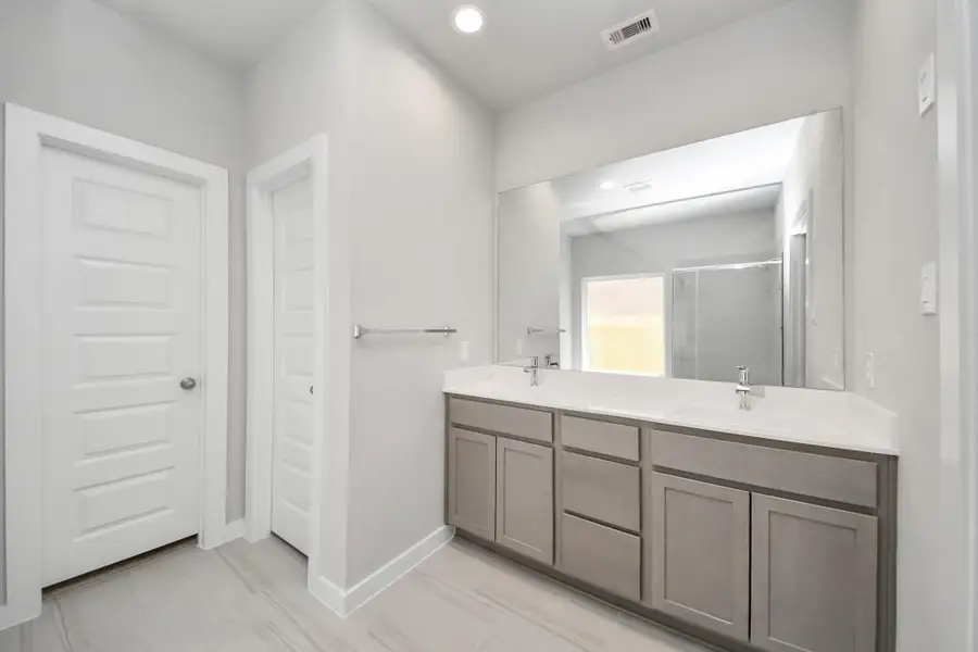 Elevate your daily routine at the elegant vanity, now equipped with double sinks, light countertops, modern hardware, and beautiful recessed lights. Elevate your daily routine at the elegant vanity, now equipped with double sinks, light countertops, modern hardware, and beautiful recessed lights.