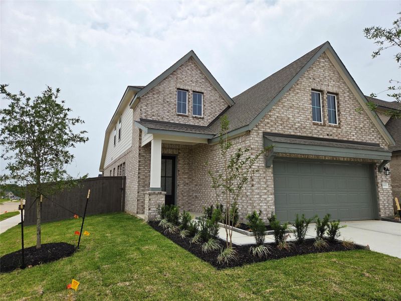 Front exterior of a new home in Emory Glen, Magnolia, TX, highlighting curb appeal (Image 18).