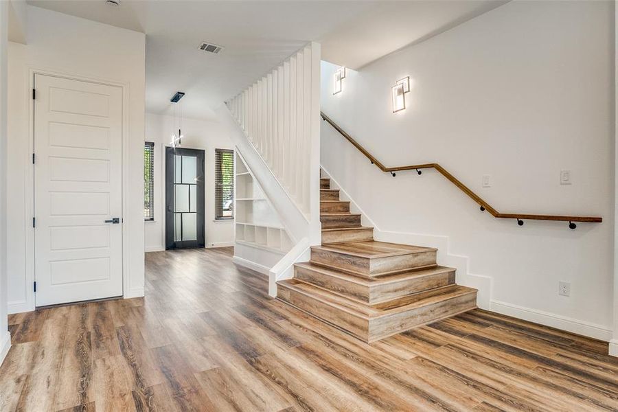 Foyer entrance with wood finished floors and stairs