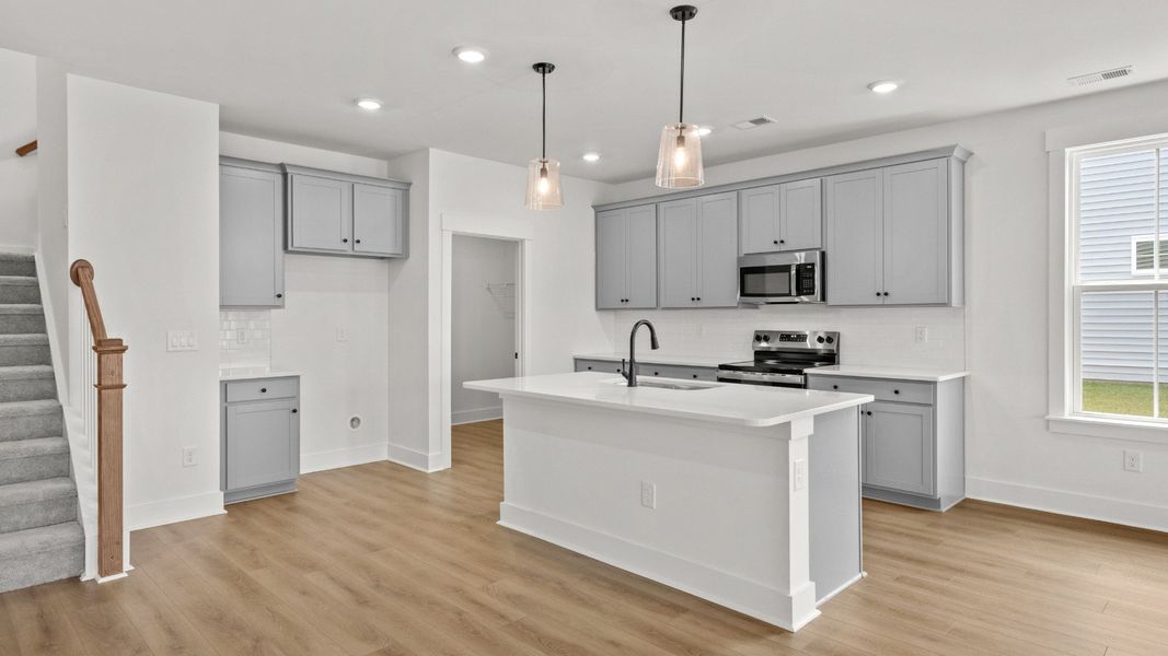 Elegant kitchen featuring a central island and soft-close cabinetry.