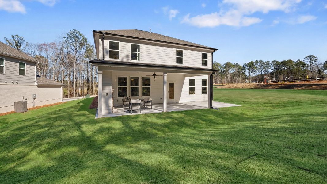 Rear exterior of home with covered patio, ceiling fan, and fireplace Rear exterior of home with covered patio, ceiling fan, and fireplace