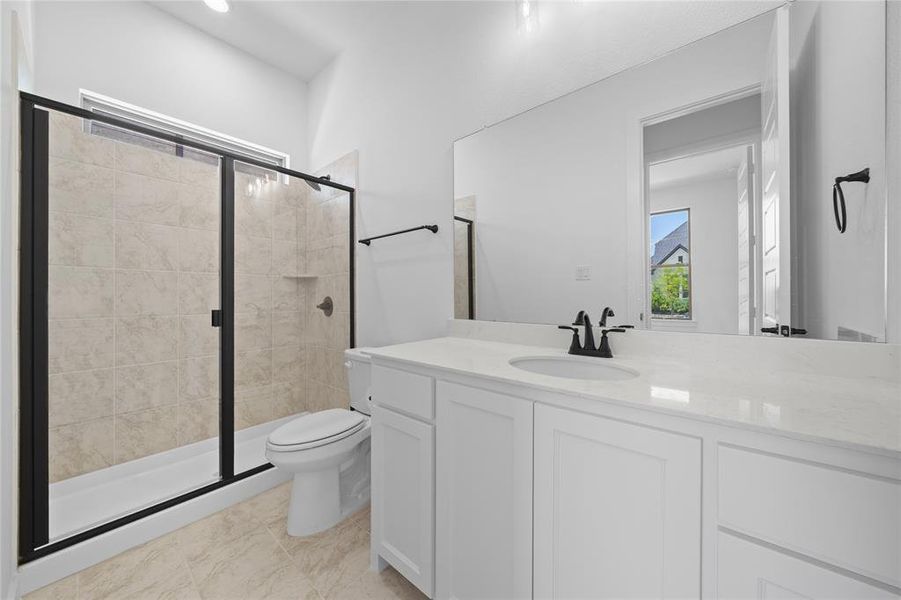 Full bathroom featuring a single vanity with white cabinetry, a light-toned countertop, and a recessed sink with a matte black faucet