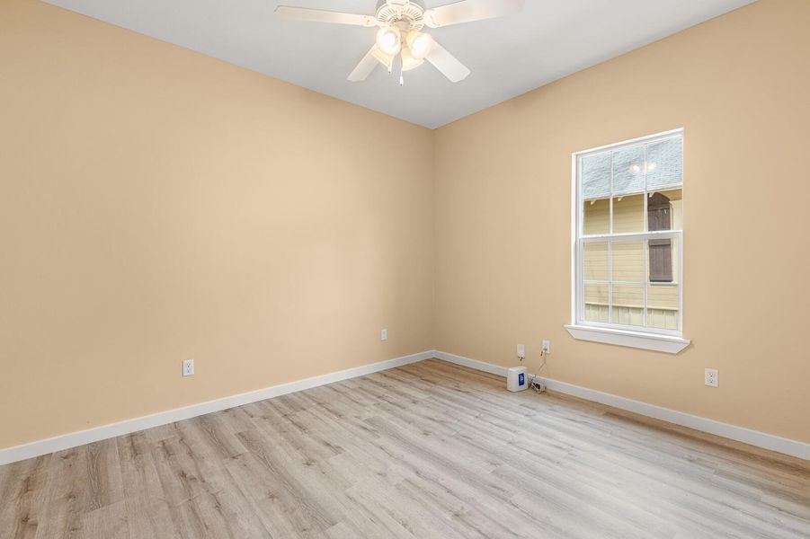 Unfurnished room featuring light wood-type flooring and ceiling fan