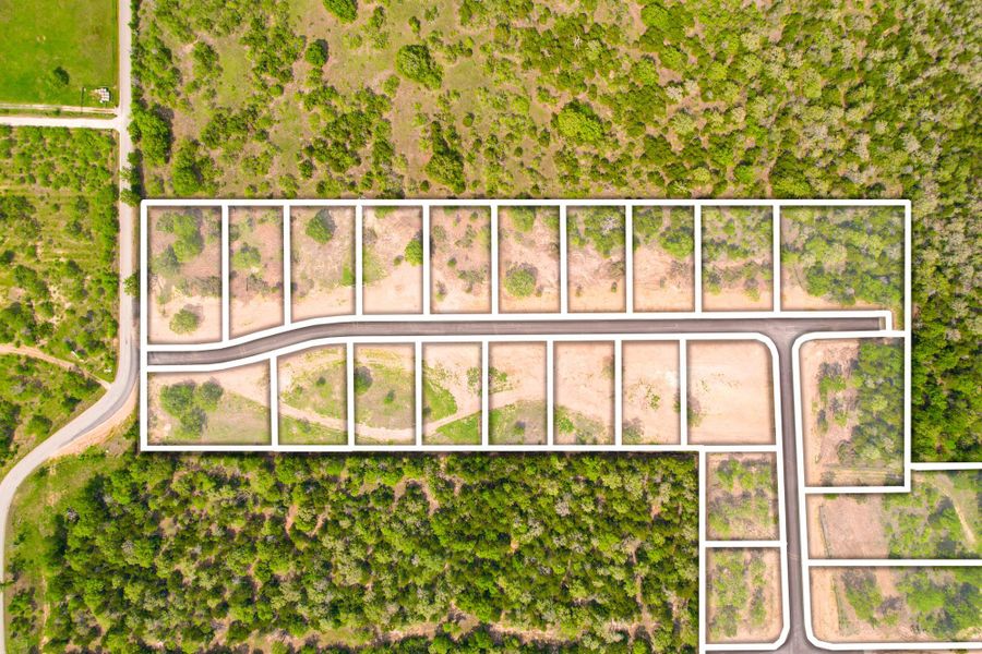 Aerial view showcasing a pristine land development opportunity with individual plots delineated.