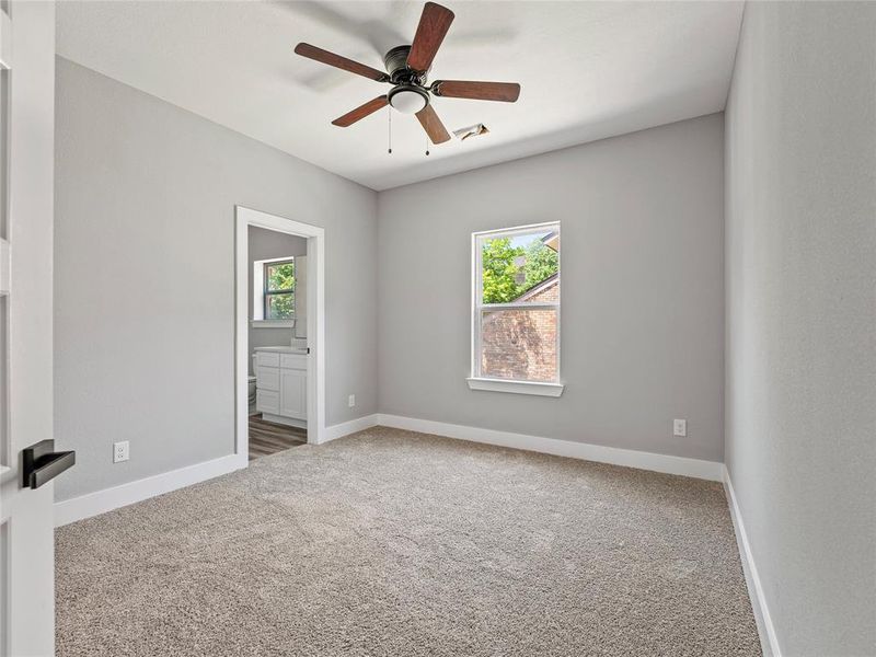 Unfurnished room featuring carpet, ceiling fan, and baseboards