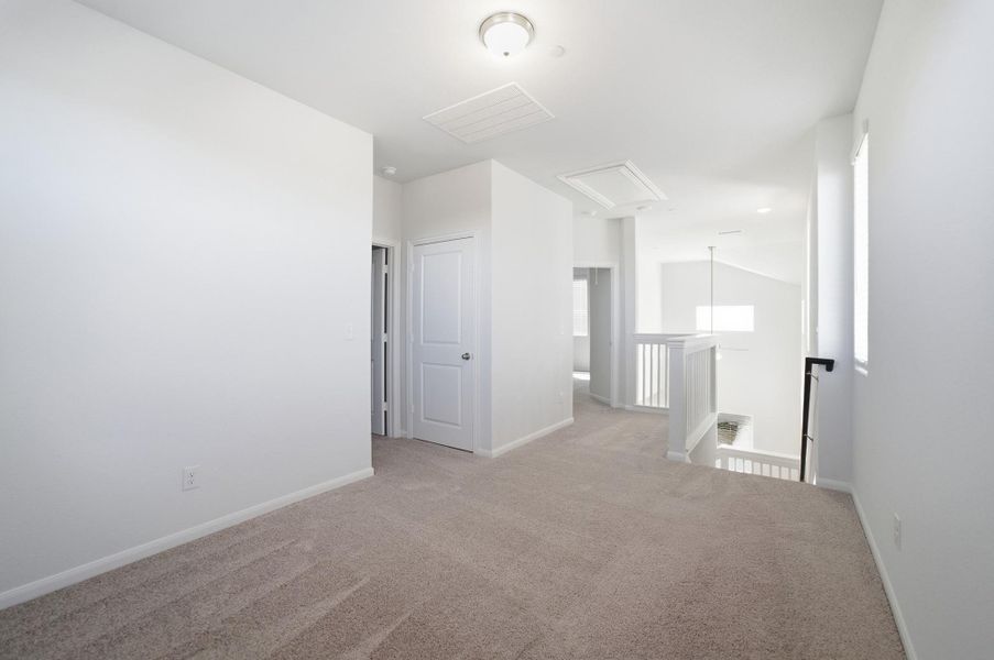 Empty room with light carpet and baseboards