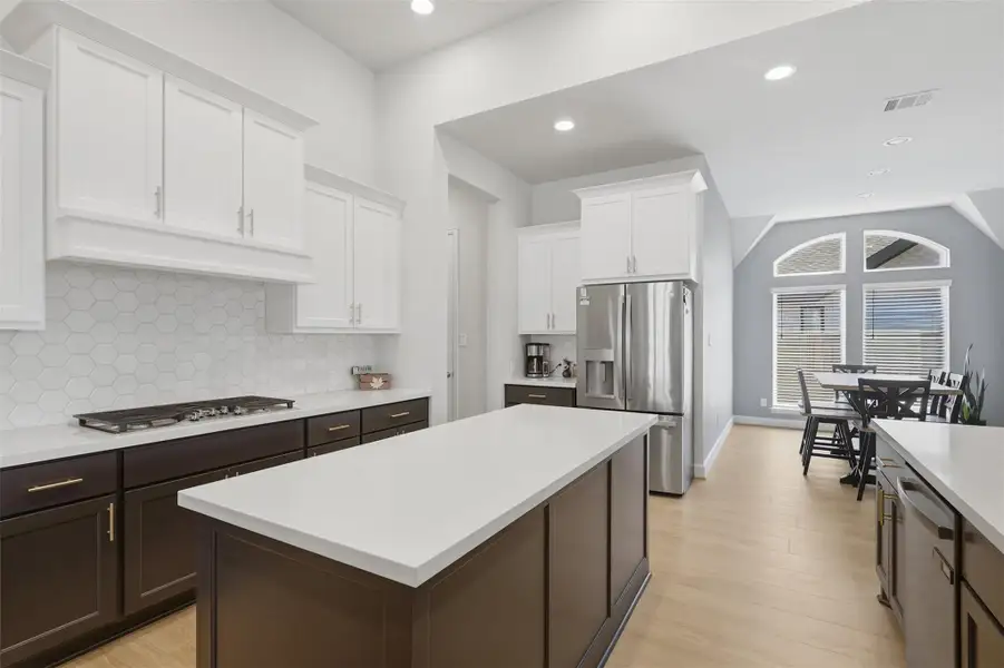 Bright kitchen showcases crisp cabinetry,modern tile backsplash and an oversized centerisland. Bright kitchen showcases crisp cabinetry,modern tile backsplash and an oversized centerisland.