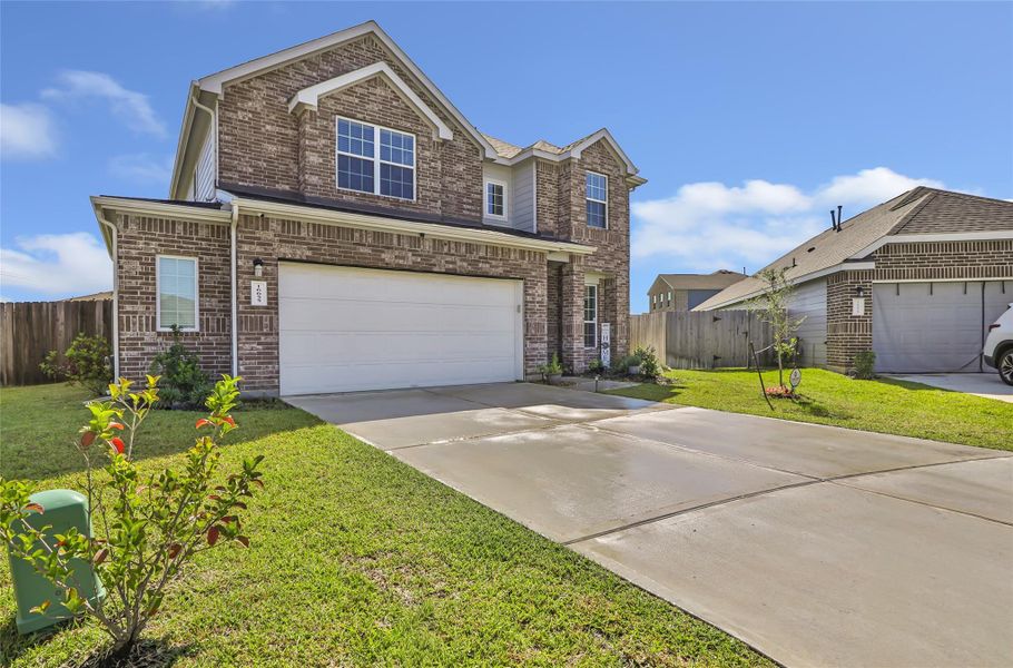 Front exterior of a new home in Granger Pines, Conroe, TX, highlighting curb appeal (Image 2).